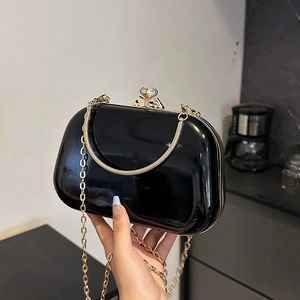 Glossy black patent leather evening clutch bag with gold rhinestone clasp and chain strap