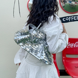 Detail view of silver sequin tote bag with reflective square sequins and long shoulder strap