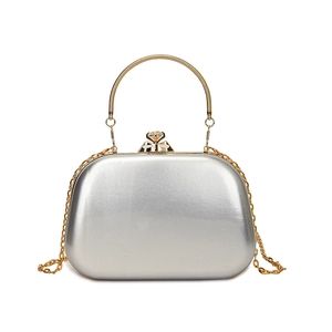 Elegant silver metallic evening bag with gold handle and chain strap on white background