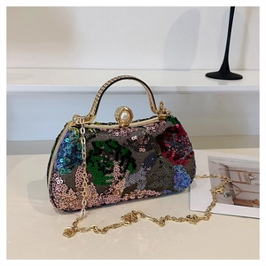 Detail of floral sequin embroidery with gold handle and pearl clasp on evening bag