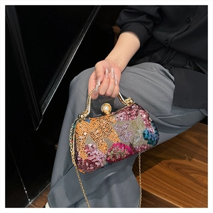 Detail of colorful sequin evening bag with gold metal frame and pearl clasp