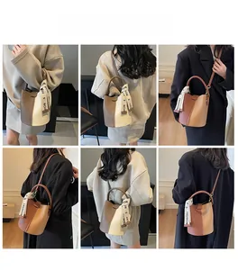 Detailed views of contrast color lychee pattern bucket bags with stylish letter straps