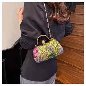 Detailed shot of multi-color sequin clutch bag with pearl clasp on gold chain strap