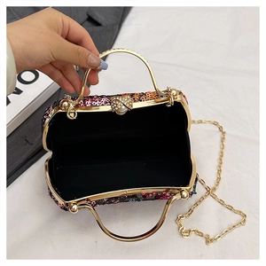 Detail of evening clutch interior with sequins, rhinestone clasp and chain strap