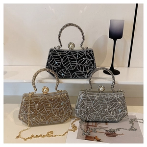 Detailed view of rhinestone evening bags in black, gold, and silver with pearl clasp