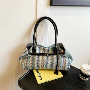 Multi-colored woven tote bag with long black leather handles for stylish casual travel