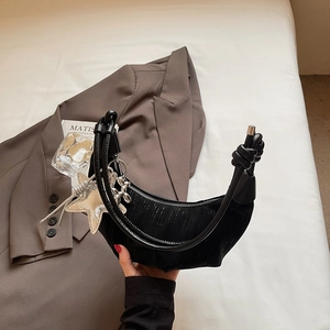Fashionable black pleated crescent shoulder bag with a metal dog pendant and knotted strap