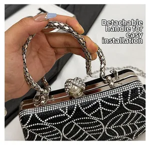 Detail showing the detachable rhinestone handle mechanism on the black evening clutch bag