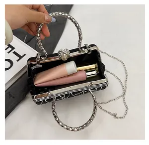 Detailed view of black rhinestone evening bag interior capacity with metal ring handles