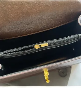Detail of premium lychee texture leather interior and golden metal twist lock closure
