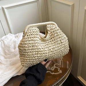 Chic beige woven straw handbag with a chunky handle and detachable gold chain strap