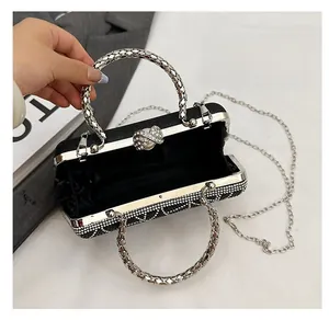 Detailed interior of black evening bag with satin lining and rhinestone bow clasp