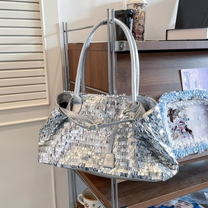 Silver sequin tote bag with leather handles and metallic clasp for trendy women's fashion