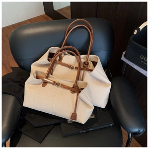 Detailed comparison of large and small canvas tote bags with brown leather handles