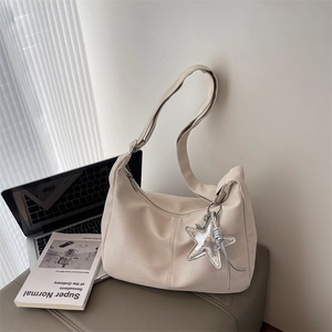 Minimalist beige pebble leather hobo bag with star charm and adjustable strap