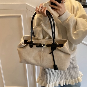 Large canvas tote bag with black leather trim and adjustable straps for women