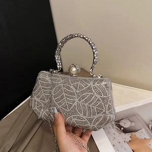 Elegant silver rhinestone evening clutch bag with round metal handle and pearl clasp