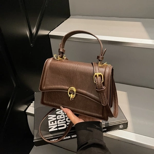 Retro dark brown crossbody bag with gold ring buckle and adjustable strap