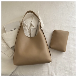 Detail view of khaki hobo tote bag and matching small pouch set in a minimalist style