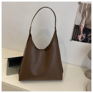 Detail view of a large brown hobo tote bag in a minimalist style for office use