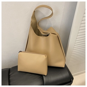 Detail shot of the large solid color hobo tote and matching zipper pouch set on a bench