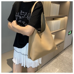 Side view of large khaki PU leather tote bag with thick strap for daily commuting
