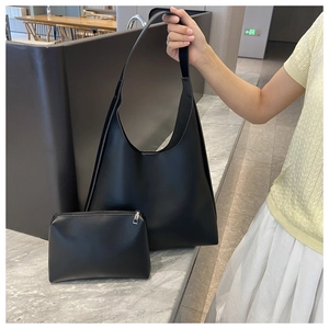 Detail view of black faux leather hobo tote bag and matching inner pouch set