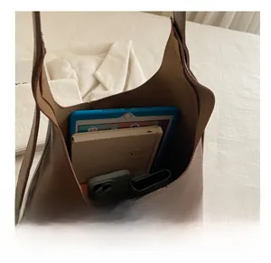 Macro view of brown large capacity soft tote bag showing interior storage for tablet and phone