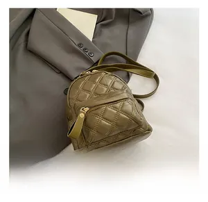 Close-up of olive green quilted backpack with elegant diamond stitching and zipper detail