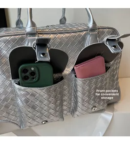 Detail of silver woven tote featuring dual front pockets with phone and wallet storage