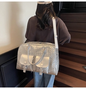 Detail of silver woven fitness bag with flap pockets and adjustable white strap