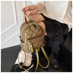 Detail view of mini olive green quilted backpack with elegant diamond pattern and gold zipper