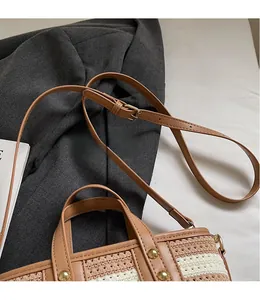 Close-up of woven bucket bag featuring metal studs and adjustable shoulder straps