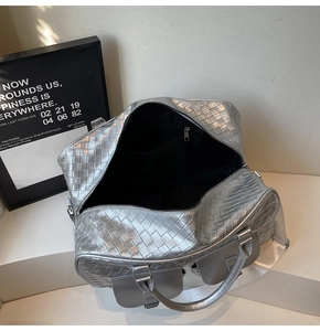 Macro view of interior storage and silver woven texture on a large commuter tote bag