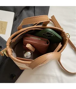 Interior view of straw bucket bag showing space for phone, wallet and cosmetics