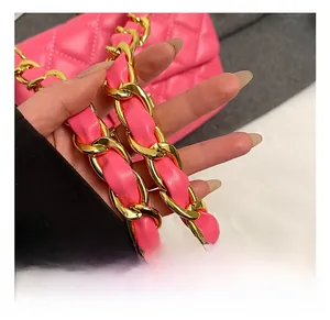 Detail shot of rose pink quilted leather texture and gold metal chain link strap