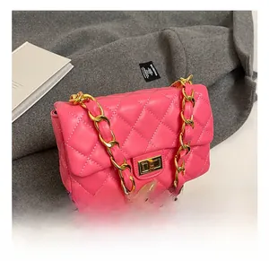 Detail shot of pink quilted crossbody bag with gold chain strap and metal lock