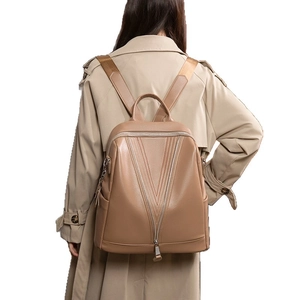 Camel pebble leather backpack for women featuring V-shaped stitching and silver zippers