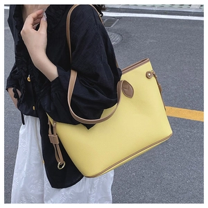 Detail of lemon yellow lychee leather tote with brown straps and side lace-up design