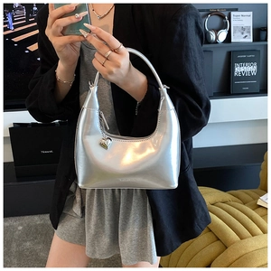 Macro shot of silver crescent hobo bag with metallic finish and heart charm detail