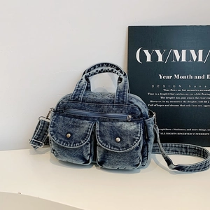 Vintage blue washed denim crossbody bag with contrast pockets and silver hardware detail