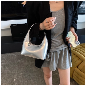 Silver metallic hobo bag with heart pendant and adjustable shoulder strap detail