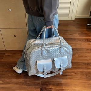 Large silver woven shoulder bag with front pockets and adjustable strap for women
