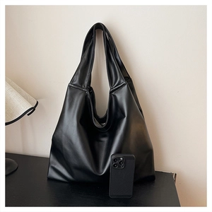 Large black leather Hobo shoulder bag shown with a smartphone to highlight spacious capacity