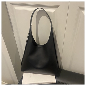 Detailed view of large black minimalist hobo shoulder bag with matte leather texture