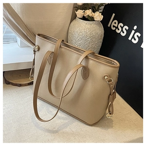 Detailed view of the khaki tote bag's lychee texture and golden metal buckle accents