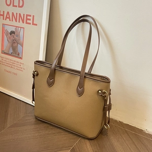 Large vintage brown leather tote bag with contrast stitching and metallic hardware details