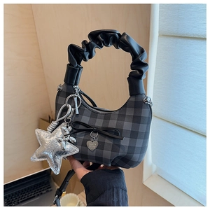 Dettaglio borsa hobo a scacchi con manico a pieghe, fiocco e accessorio a forma di stella