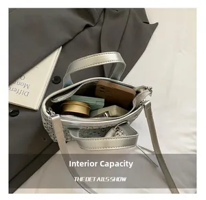 Top view of silver rhinestone bucket bag interior showing capacity for phone and cosmetics