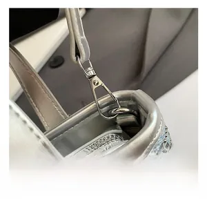 Detail of high-quality zinc alloy lobster clasp and rhinestone-studded denim bag strap